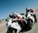 two people riding sports bikes on gray asphalt road during daytime